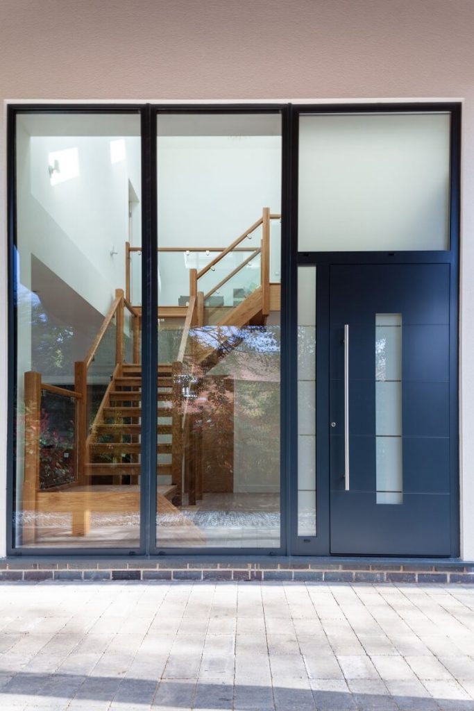 A lovely black front door with glass windows.